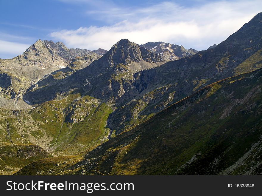 Mountains of the Valtellina with the glacier and stream