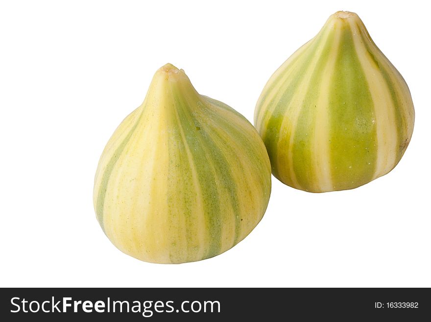 Ripe fruits of a fig on a white surface.