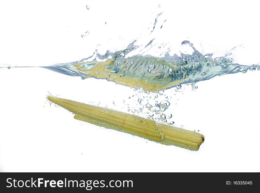 Fresh Babycorn drop to water in isolated. Fresh Babycorn drop to water in isolated