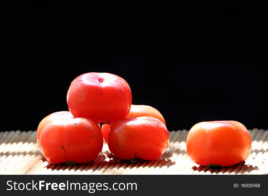 Delicious persimmon on the black backgrounds.