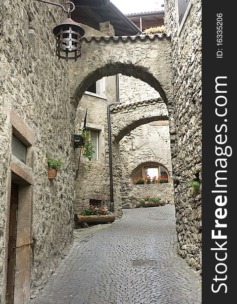 Passage of stone arcs in the medieval Italian village near Garda lake. Passage of stone arcs in the medieval Italian village near Garda lake