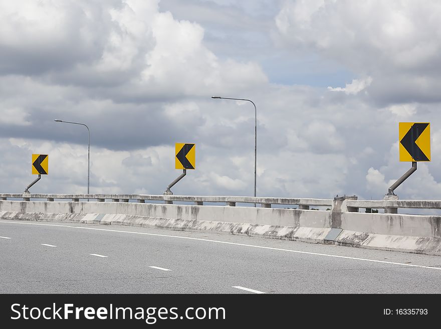 Sign turn on street to bridge. Sign turn on street to bridge