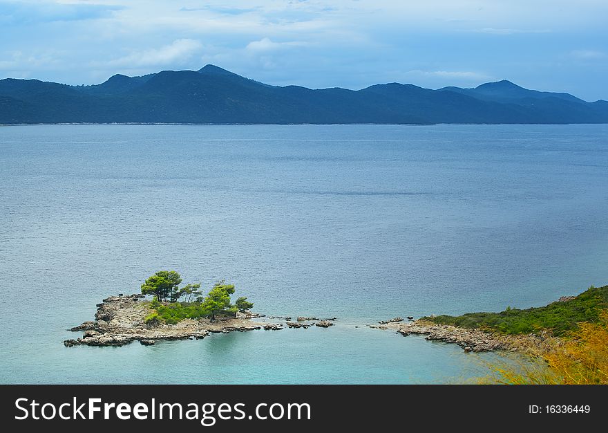 Little Island With Tree And Clouds,in Summertime