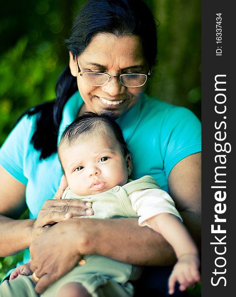 A happy scene of a grandmother and a newborn baby. A happy scene of a grandmother and a newborn baby