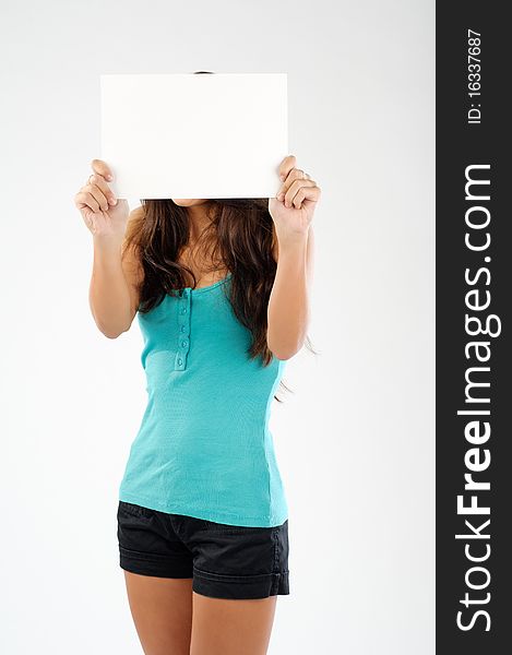 Young brunette model holding signboard in front of her face. Young brunette model holding signboard in front of her face