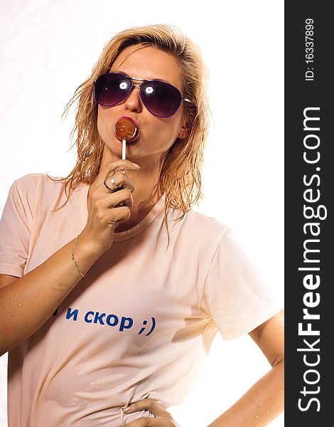 Beautiful girl in sunglasses with a lollipop. Beautiful girl in sunglasses with a lollipop