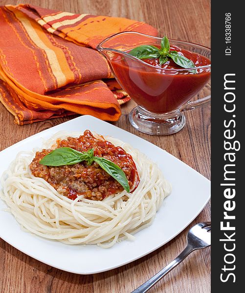Spaghetti bolognese with cheese and basil