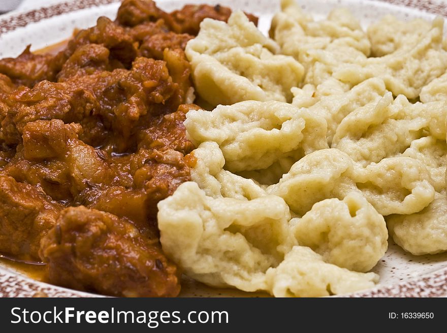 Goulash with gnocchi on a plate. Hungarian food