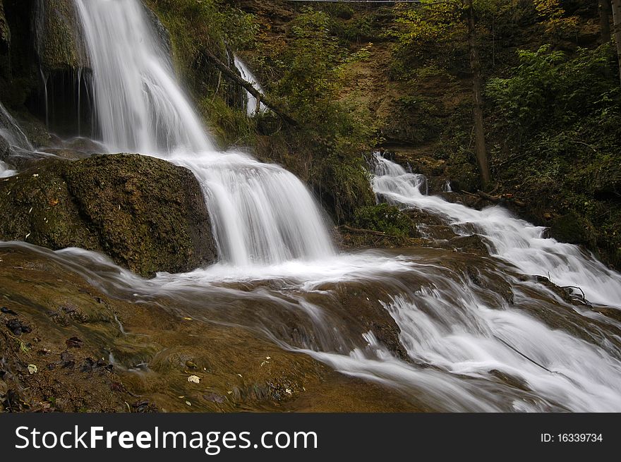 Waterfall in the middle of the village in central Slovakia Lucky