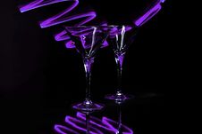 Pair Martini Glasses With Purple Light Trails Royalty Free Stock Image