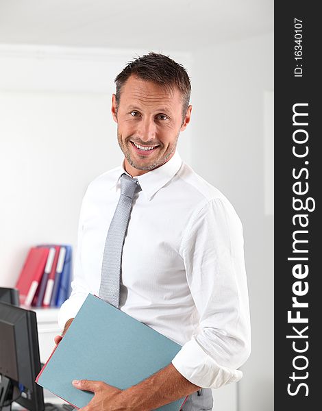 Happy businessman with thumb up in the office. Happy businessman with thumb up in the office