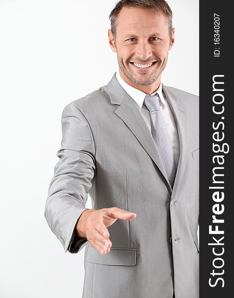 Businessman extending hand towards camera. Businessman extending hand towards camera