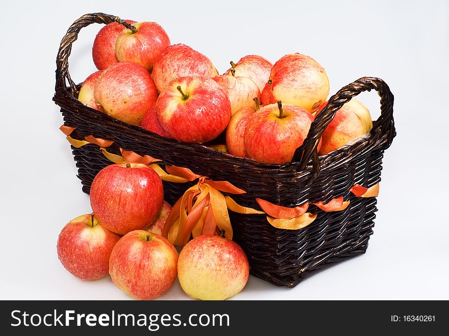 Basket with red apples on the white background