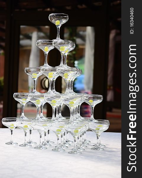 Glasses with grapes stand on a table in the pyramid form. Glasses with grapes stand on a table in the pyramid form