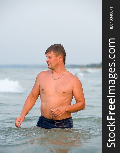 Caucasian young man standing in water