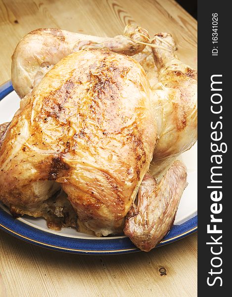 Delicious Roasted Chicken ready to serve at the kitchen table