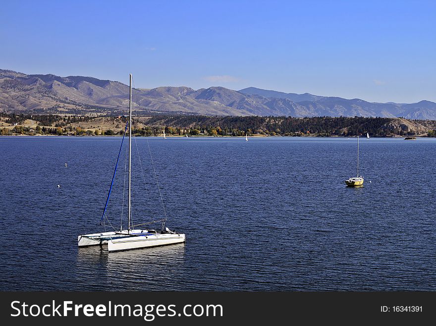 Two anchored sailboats in the middle of a lake on a summer's day in Montana