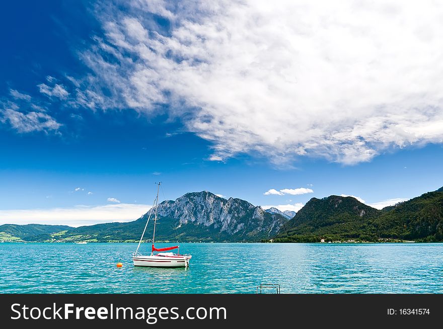 Yacht on a blue alpine lake. Salzkammergut. Austria. Yacht on a blue alpine lake. Salzkammergut. Austria