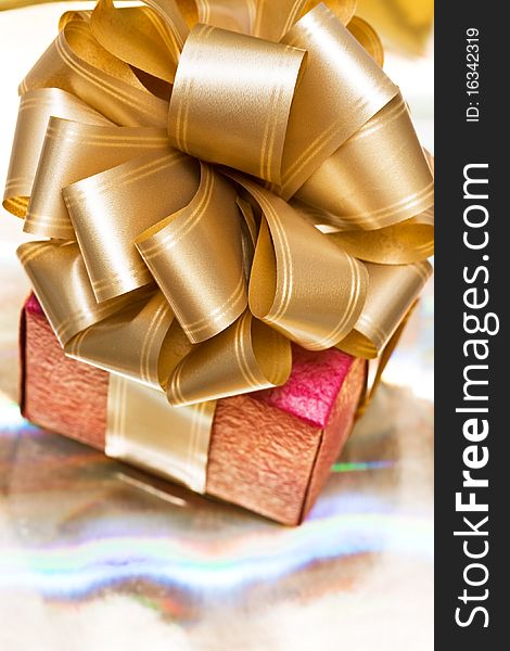 Red gift box on golden background