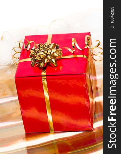 Red gift box on golden background