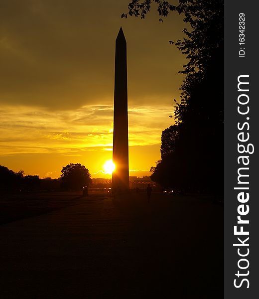 Washington monument at dawn with the flag circle around it and a beautiful sky