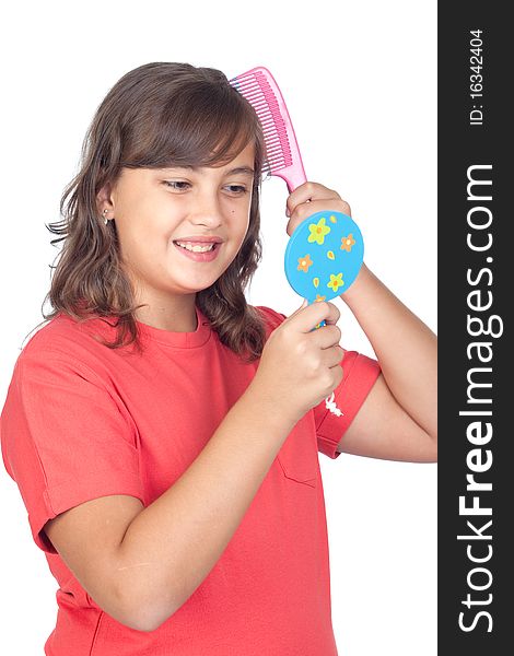 Preteen girl combing with a comb in front of a mirror isolated on white background