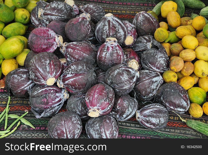 Natural texture with black collard and yellow lemons