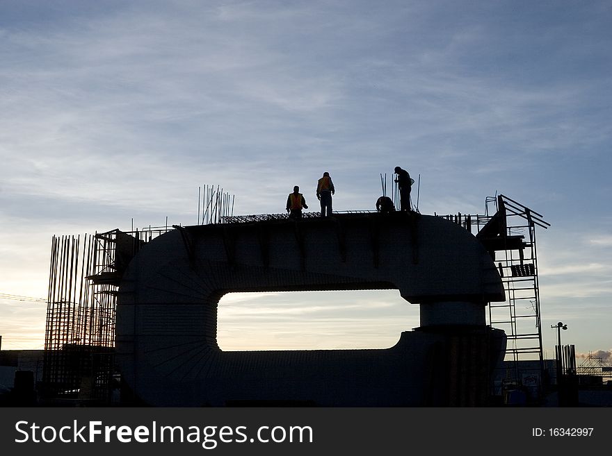 Silhouette of construction and workers at twilight. Silhouette of construction and workers at twilight