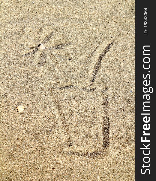 Drawing  a cocktail glass on sand. Drawing  a cocktail glass on sand