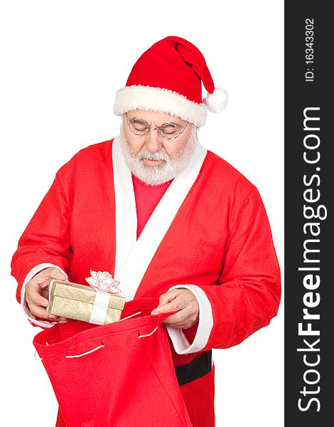Santa Claus getting a gift from his sack isolated on white background