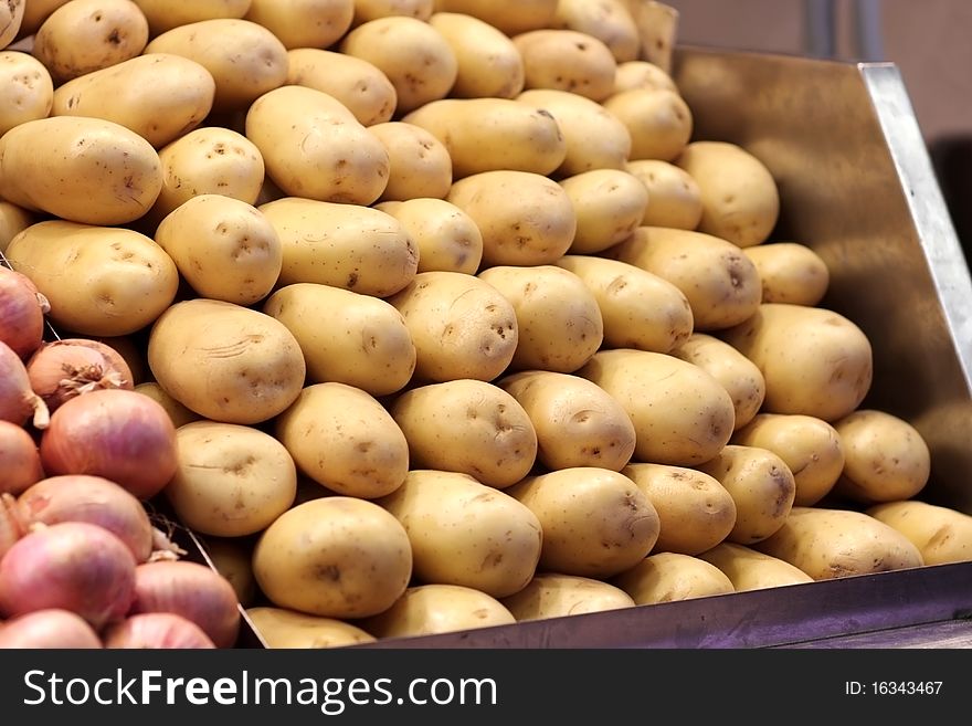 Fresh yellow baked potatoes at the market