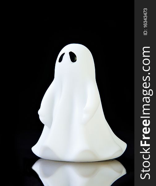 The perfect ghost on black background with reflection and copy space