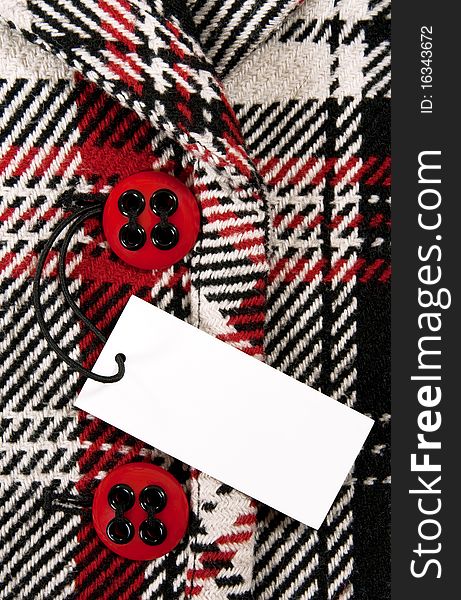 Blank price tag on checked coat with red buttons