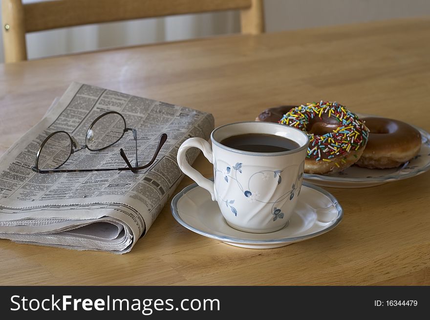 Coffee and donuts with the morning paper