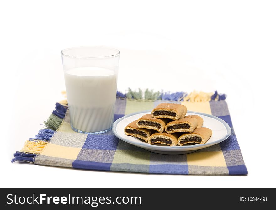 Fig cookies on a plate with a glass of milk. Fig cookies on a plate with a glass of milk