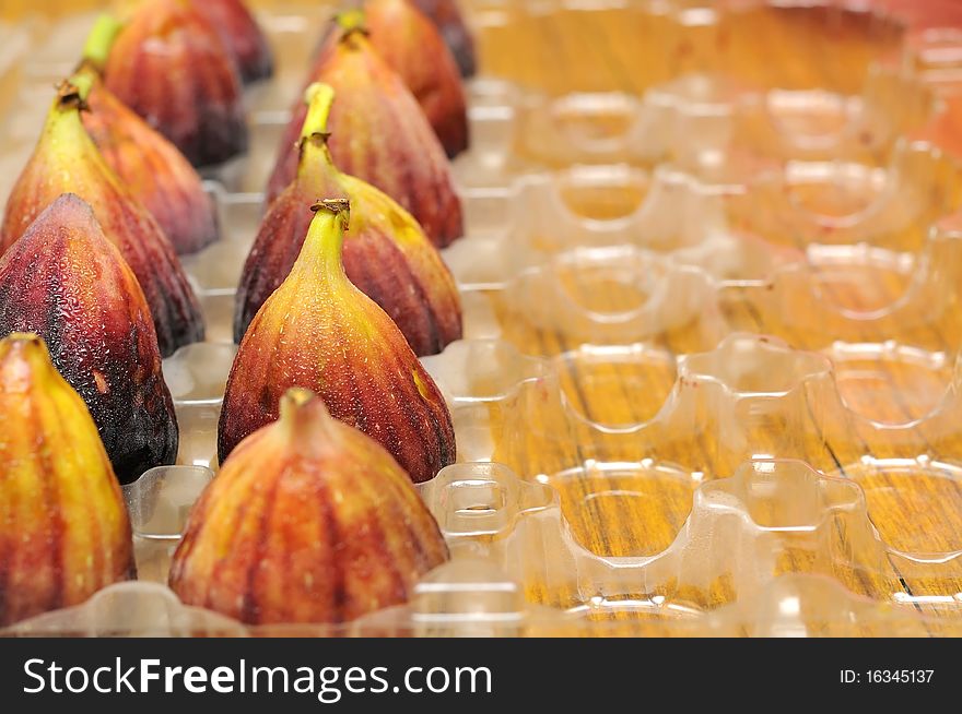 Neatly arranged rows of freshly picked ripe figs. For food and beverage, healthy lifestyle, and fruits and vegetables concepts. Neatly arranged rows of freshly picked ripe figs. For food and beverage, healthy lifestyle, and fruits and vegetables concepts.