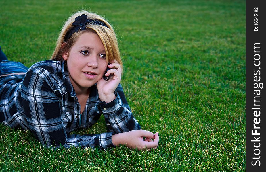 Attractive teenage girl talking on a cell phone