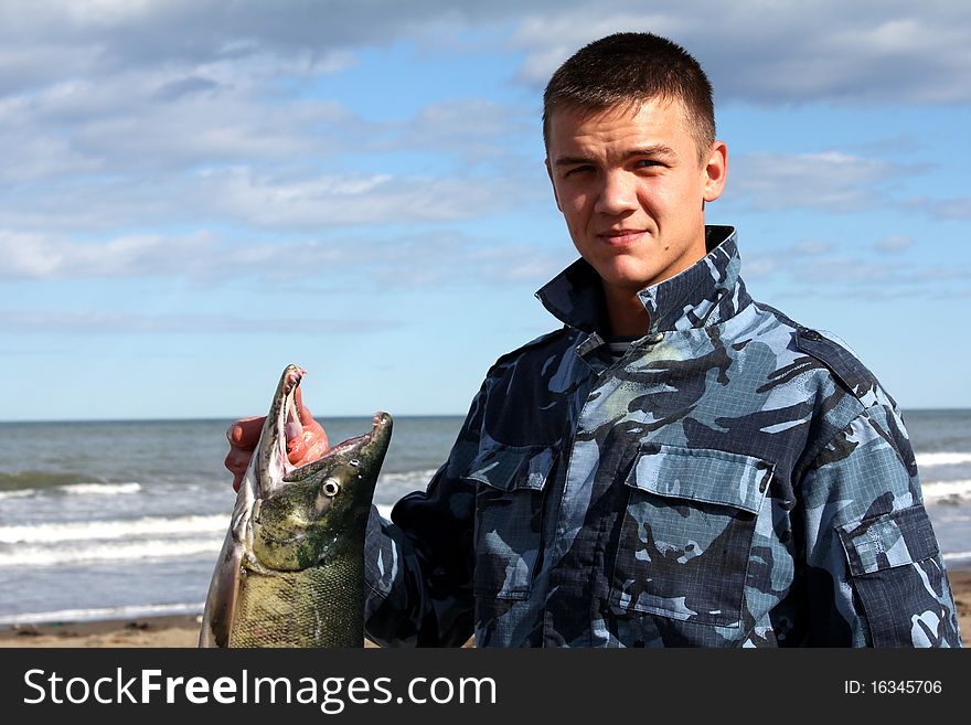 The young man with fish in hands, Fisherman