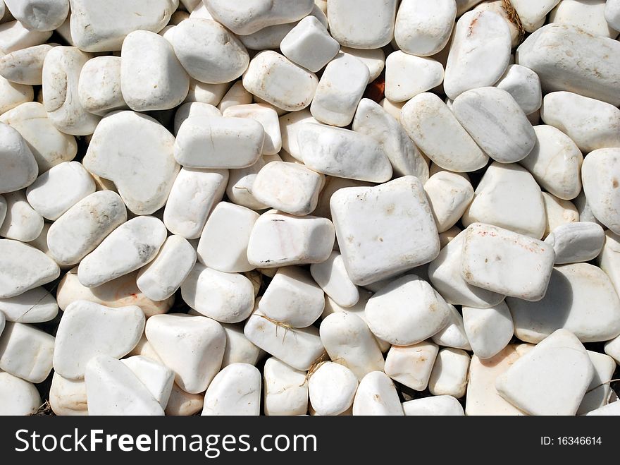 On the wet beach sand, pebbles