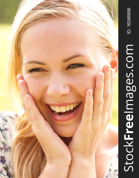 Outdoor portrait of laughing beautiful lady. Outdoor portrait of laughing beautiful lady