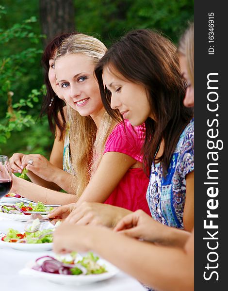 Group of beautiful girls drinking wine in the park