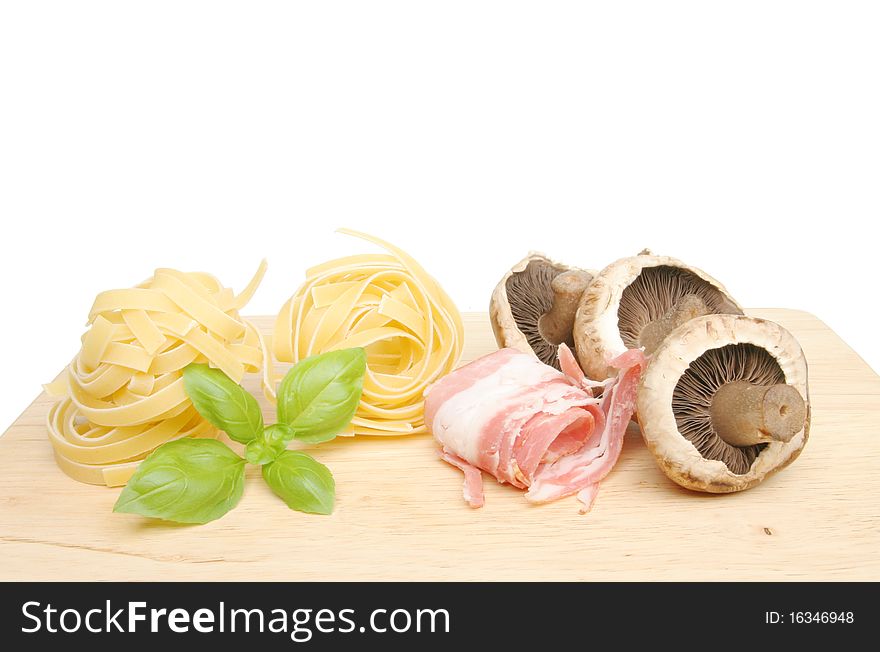 Pasta ingredients on a wooden food preparation board