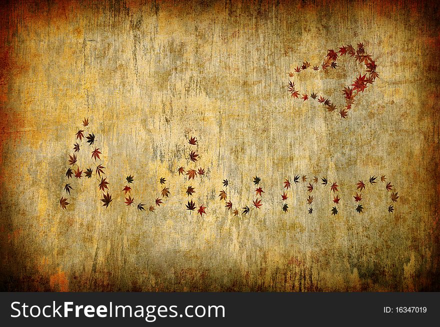 Grunge background with autumn letters and heart shape made by leaves