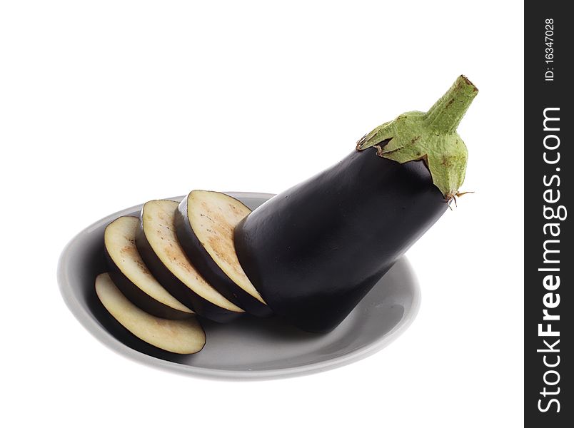 Sliced egg-plant on plate isolated over white background