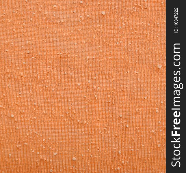 Close orange fine mesh with white dots. Close orange fine mesh with white dots