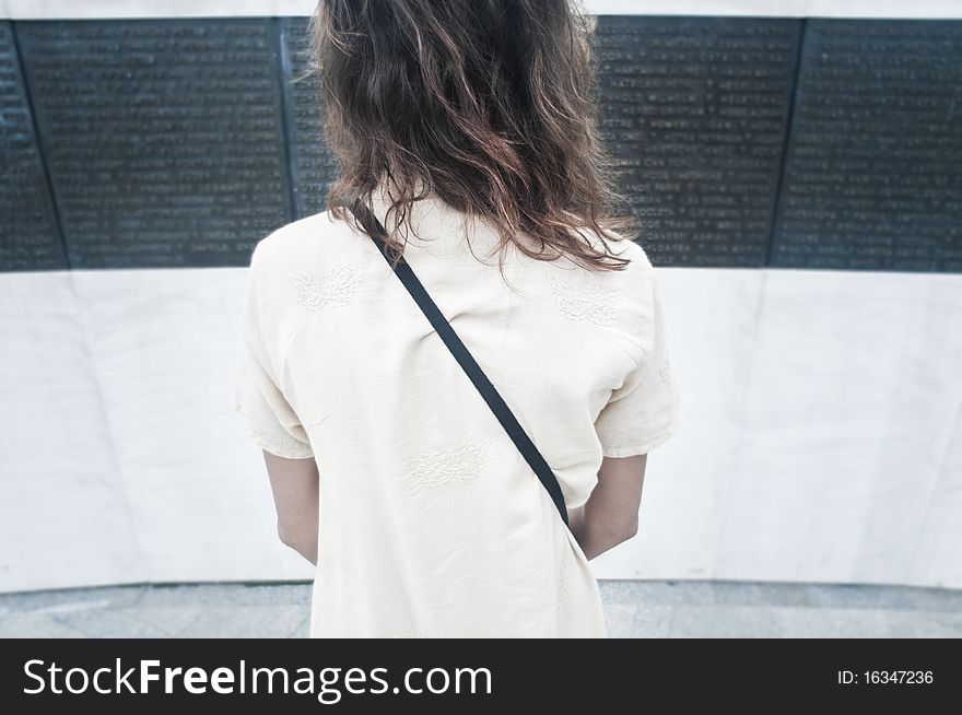 Young girl looking at Memorial monument from Bucharest, Romania