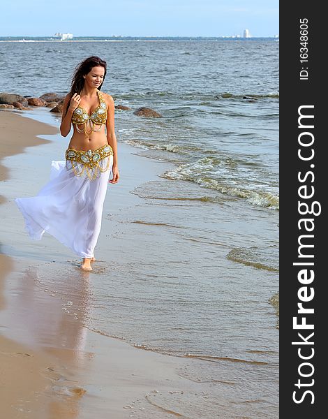 Beautiful Young Girl Walking On Beach