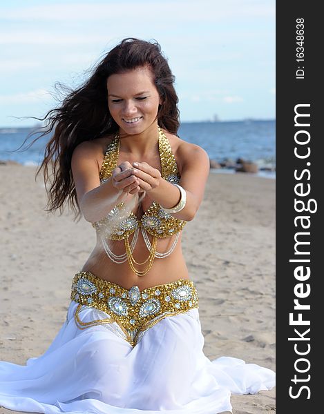 Beautiful woman play with sand