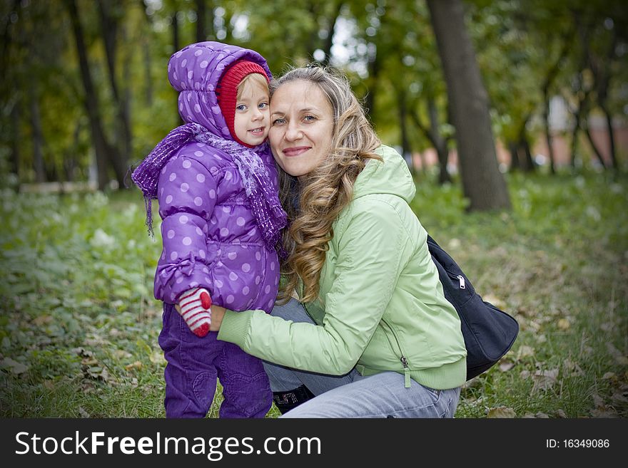 Mother and daughter having fun in autumn park. Mother and daughter having fun in autumn park