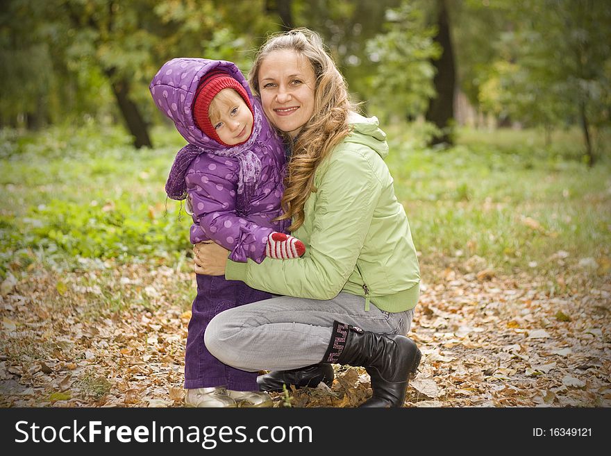 Mother And Daughter In Autumn Park